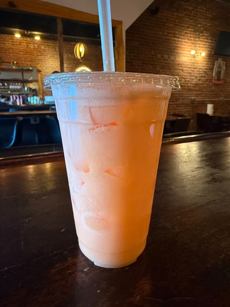 Peach frozen slushie with straw