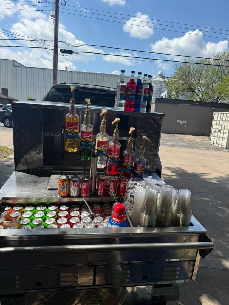 Soda bar cart with syrups and chilled drinks at The Sandwich Shop